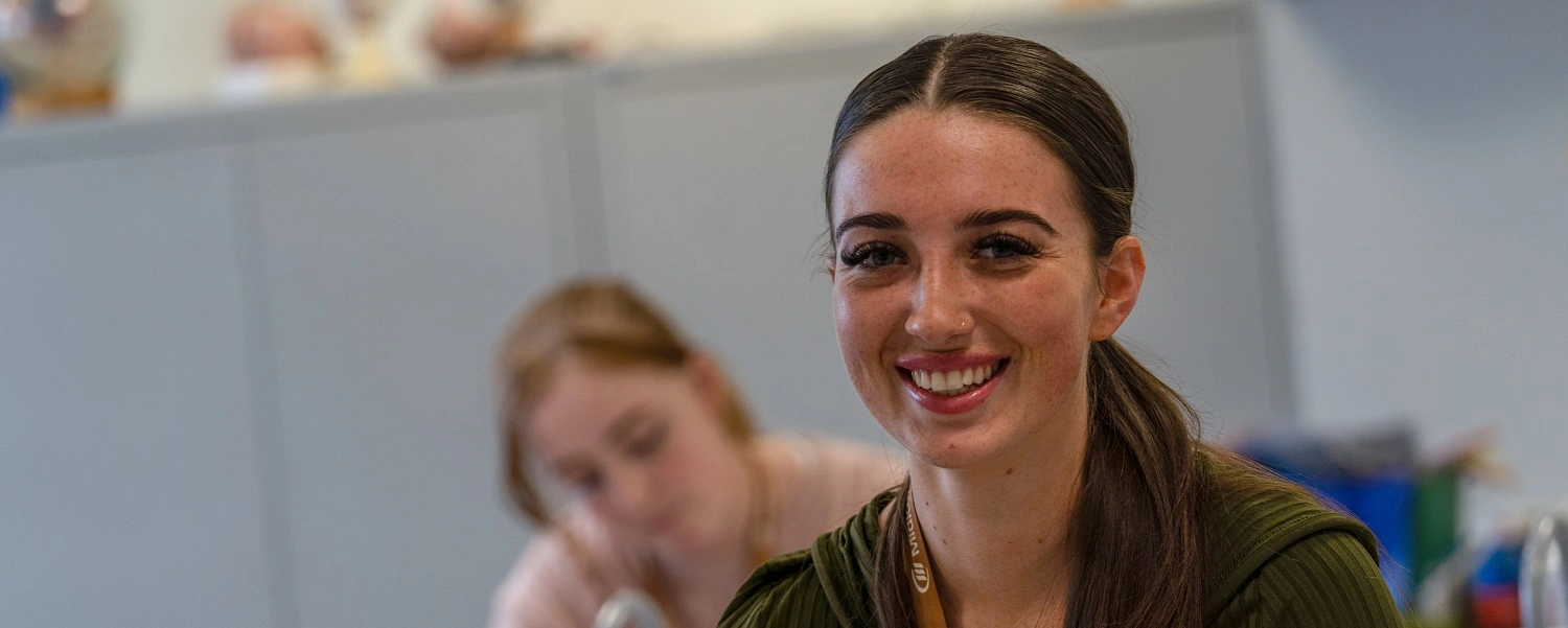 Access student smiles at camera